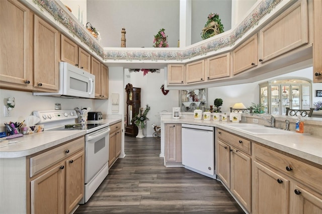 kitchen with white appliances, sink, dark hardwood / wood-style flooring, kitchen peninsula, and light brown cabinets