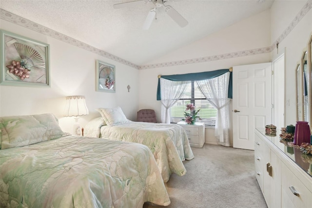 bedroom featuring lofted ceiling, a textured ceiling, light colored carpet, and ceiling fan