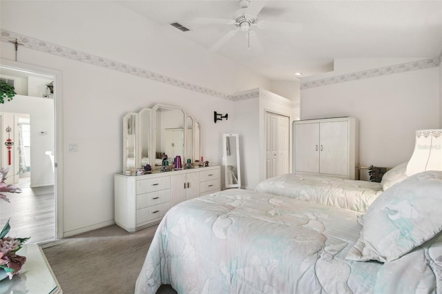 carpeted bedroom featuring a closet, ceiling fan, and vaulted ceiling