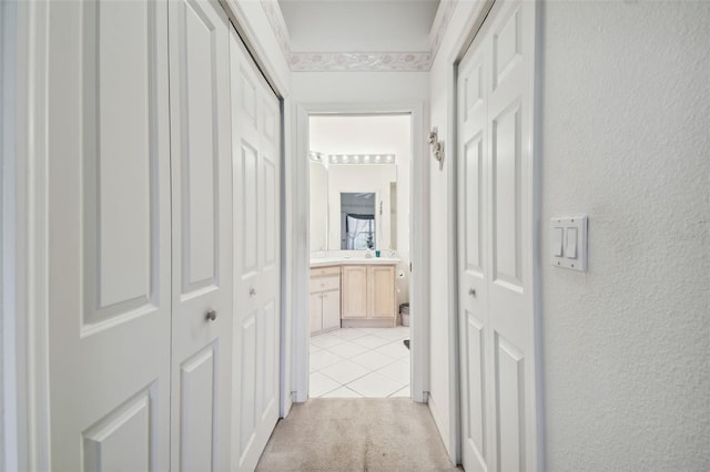 corridor featuring light colored carpet