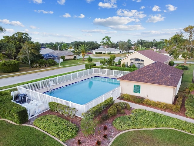 view of pool featuring a lawn