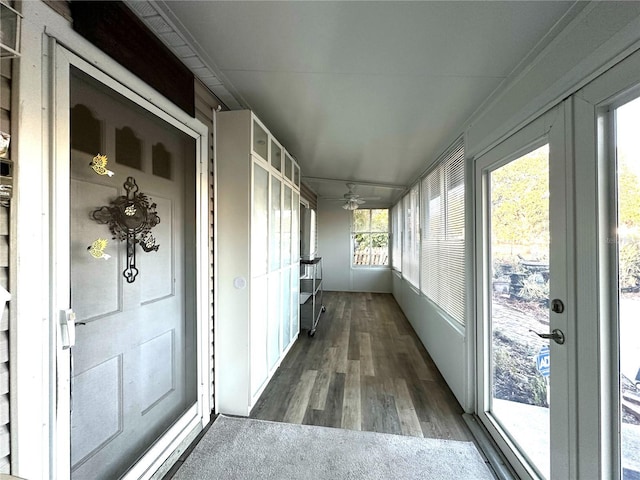 unfurnished sunroom featuring ceiling fan