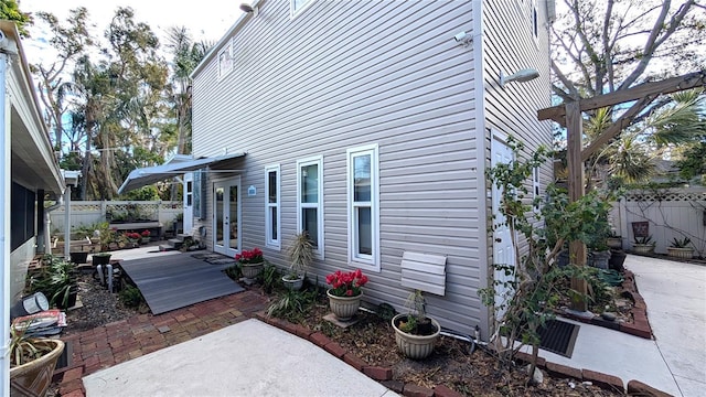 view of home's exterior with french doors, a patio area, and a fenced backyard