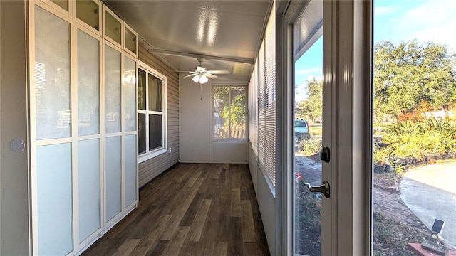 unfurnished sunroom with ceiling fan