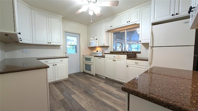 kitchen featuring dark wood-type flooring, white appliances, white cabinets, and plenty of natural light