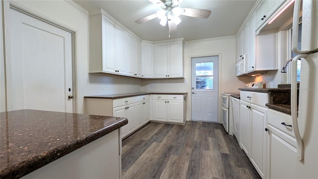 kitchen with ceiling fan, white appliances, dark wood-style floors, white cabinetry, and dark stone counters