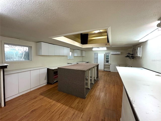 kitchen with light countertops, modern cabinets, white cabinets, and a center island