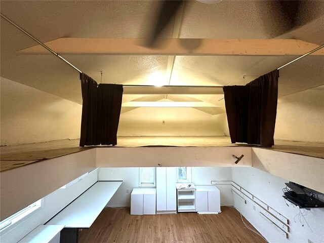 kitchen featuring white range oven, light countertops, wood finished floors, and white cabinetry