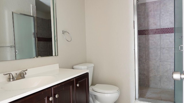 bathroom featuring walk in shower, vanity, and toilet