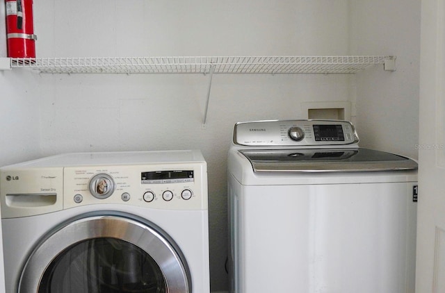 clothes washing area with independent washer and dryer