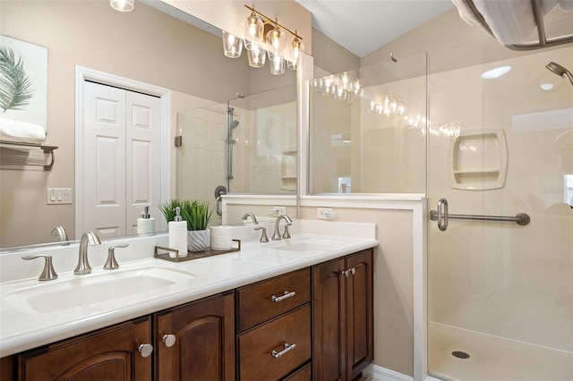 bathroom with a shower with door, vaulted ceiling, and vanity