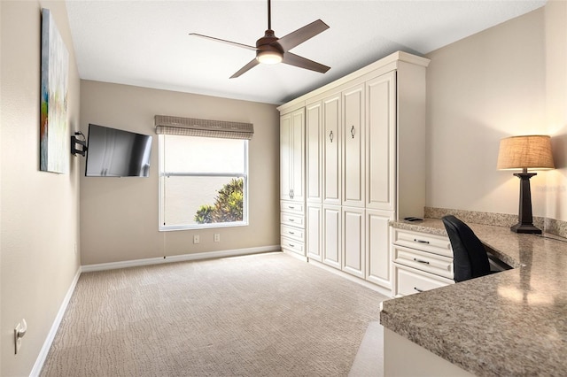 bedroom featuring a closet, light colored carpet, and ceiling fan