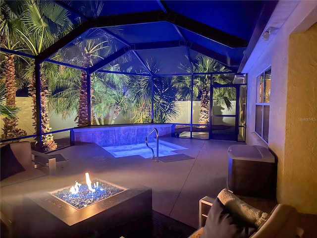 view of patio with a fire pit and a lanai