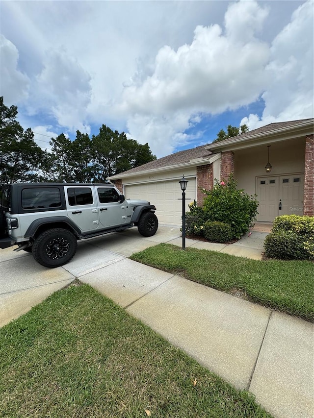 view of home's exterior with a garage and a lawn