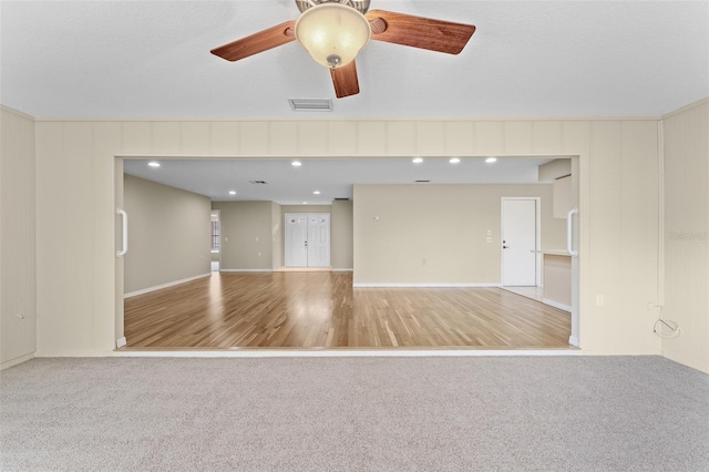 unfurnished living room featuring hardwood / wood-style flooring and ceiling fan