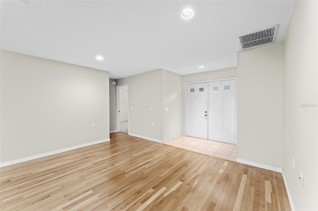 spare room featuring light hardwood / wood-style floors