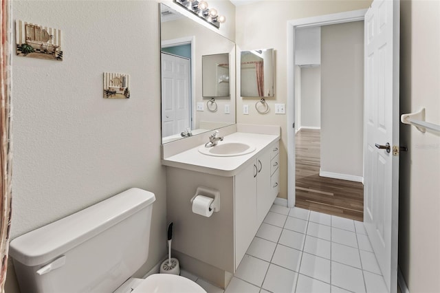 bathroom featuring vanity, toilet, and tile patterned floors