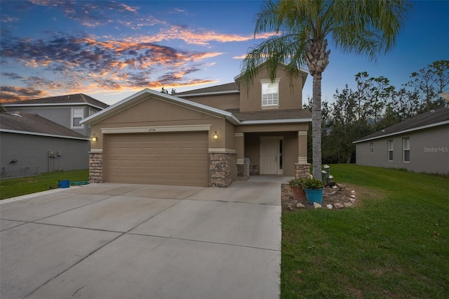 view of front facade with a garage and a lawn