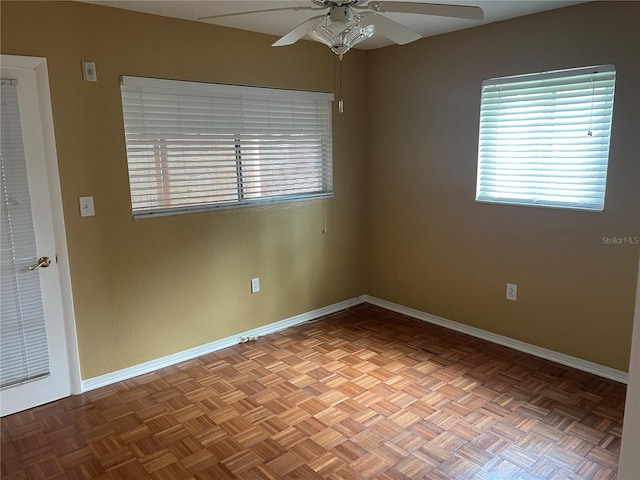 empty room with parquet floors and ceiling fan