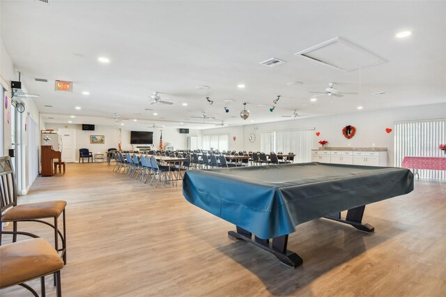 recreation room with ceiling fan, pool table, and light wood-type flooring