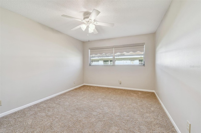 carpeted spare room with ceiling fan and a textured ceiling