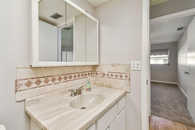 bathroom featuring vanity and wood-type flooring