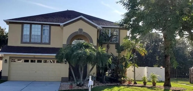 2001 Rain Dance Pl, Brandon, FL 33510 - view of front of home with stucco siding, an attached garage, driveway, and roof with shingles
