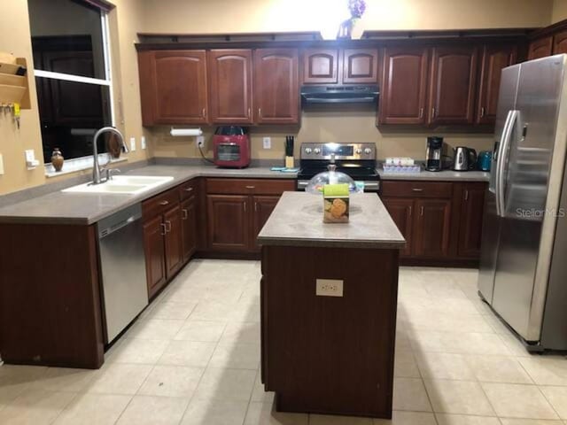 2001 Rain Dance Pl, Brandon, FL 33510 - kitchen with stainless steel appliances, exhaust hood, a sink, a kitchen island, and light countertops