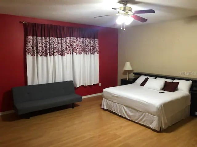 bedroom featuring hardwood / wood-style flooring and ceiling fan