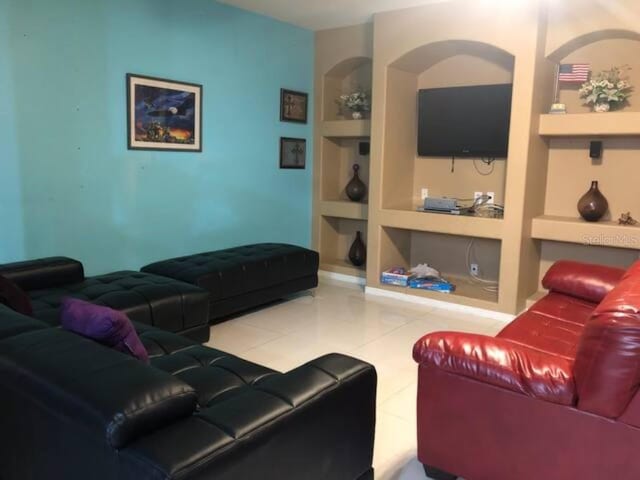 2001 Rain Dance Pl, Brandon, FL 33510 - living room with built in shelves and tile patterned floors