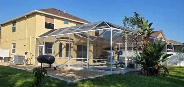 2001 Rain Dance Pl, Brandon, FL 33510 - back of house featuring stucco siding, a patio, a lanai, central AC, and ceiling fan