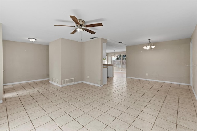 unfurnished room with ceiling fan with notable chandelier and light tile patterned floors