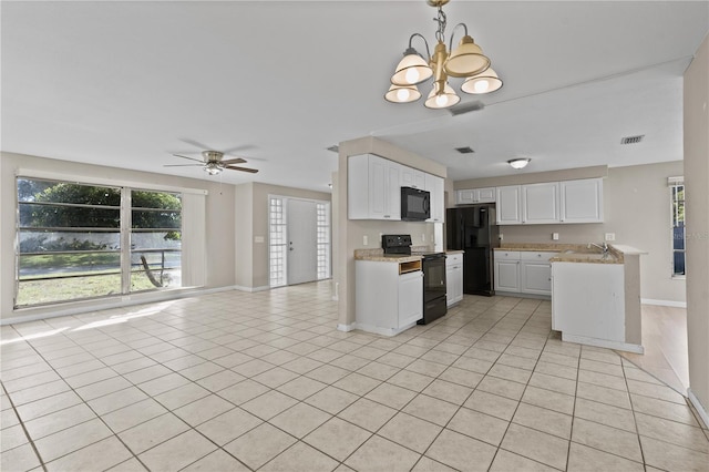 kitchen featuring black appliances, hanging light fixtures, light tile patterned floors, white cabinets, and ceiling fan with notable chandelier