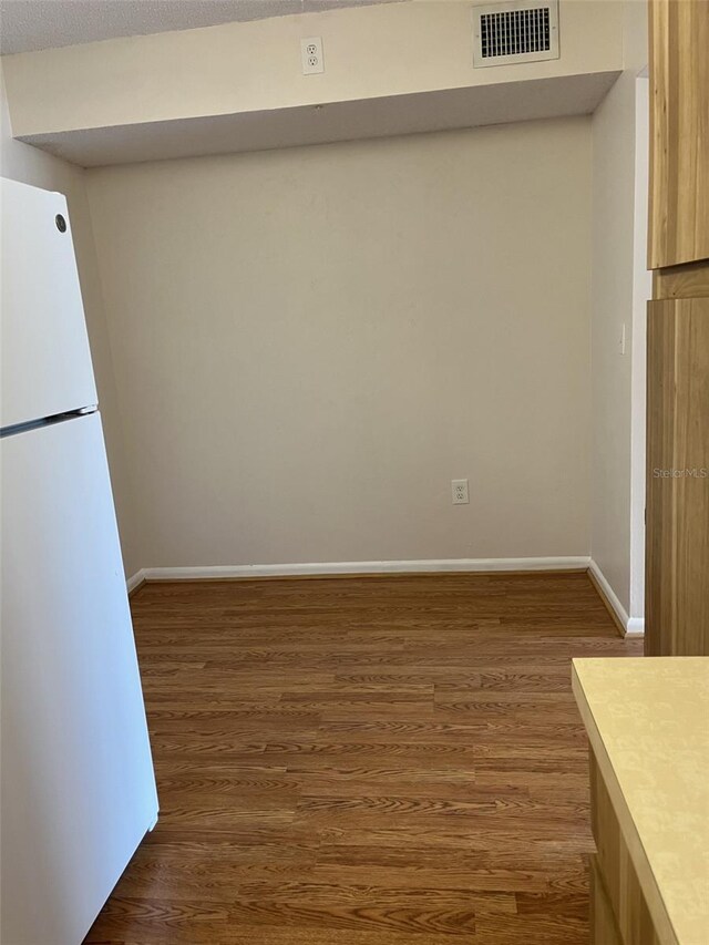 2688 Pine Ridge Way N Unit D1, Palm Harbor, FL 34684 - unfurnished dining area featuring wood finished floors and baseboards