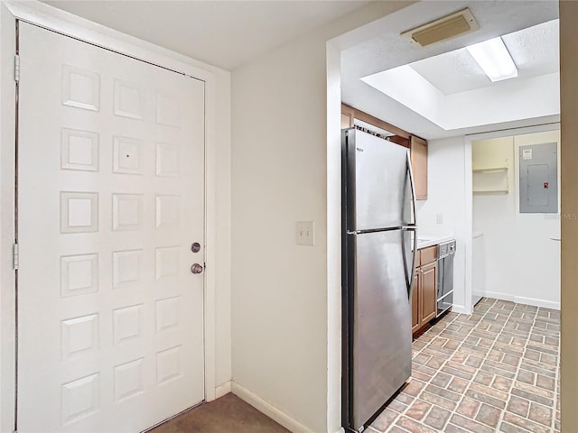 kitchen with electric panel and stainless steel refrigerator