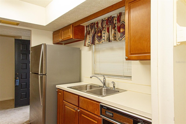 kitchen featuring carpet floors, stainless steel refrigerator, sink, and dishwasher