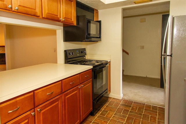 kitchen featuring dark carpet, a textured ceiling, and black appliances