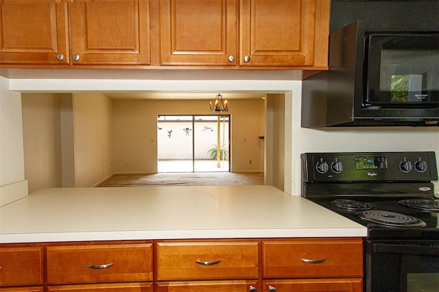 kitchen featuring an inviting chandelier and black appliances