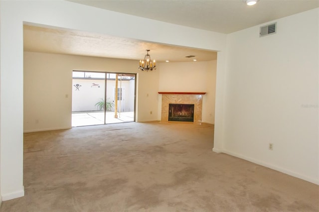 unfurnished living room featuring carpet floors and a chandelier