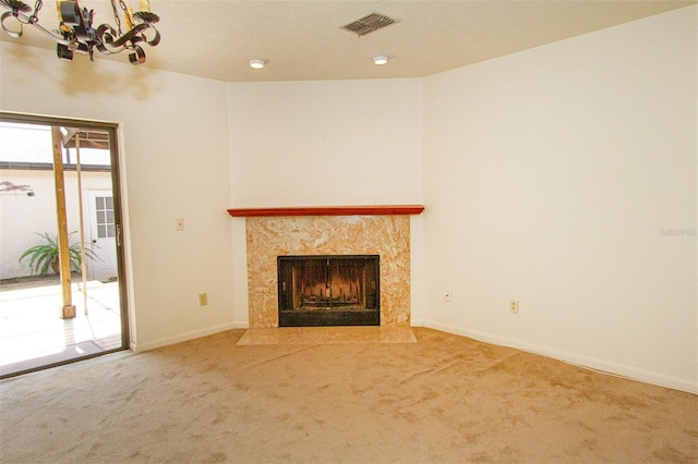 unfurnished living room featuring a fireplace and carpet flooring