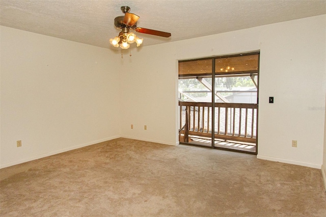 carpeted spare room featuring ceiling fan and a textured ceiling