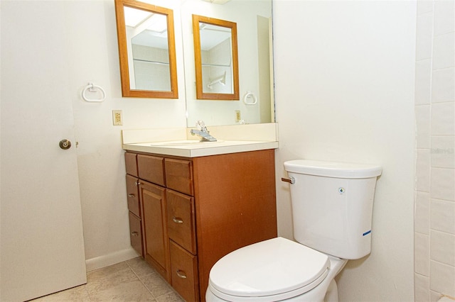 bathroom with vanity, toilet, and tile patterned floors