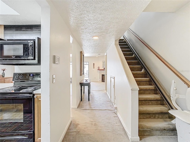 stairs featuring a textured ceiling