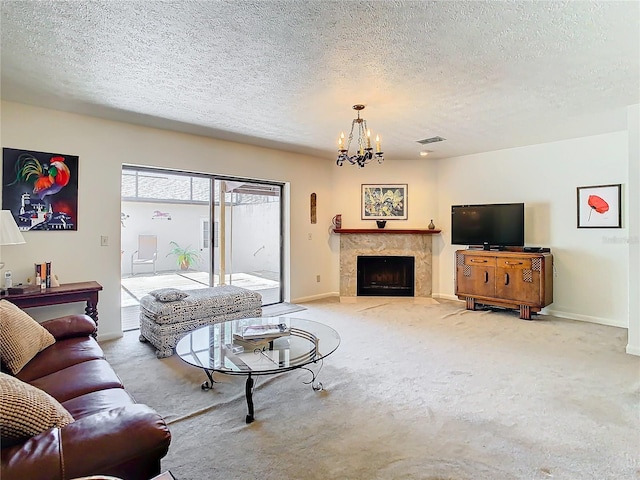 carpeted living room with an inviting chandelier and a textured ceiling