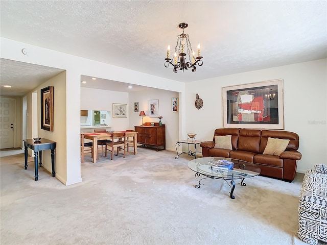 carpeted living room featuring a notable chandelier and a textured ceiling