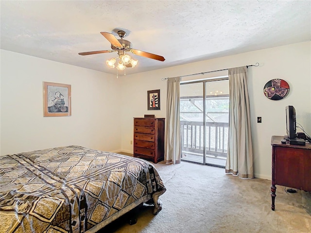 bedroom featuring access to exterior, light colored carpet, a textured ceiling, and ceiling fan