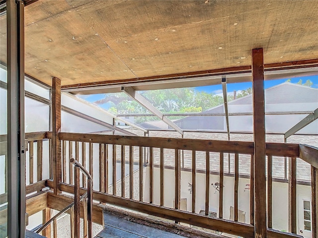 unfurnished sunroom featuring lofted ceiling and plenty of natural light