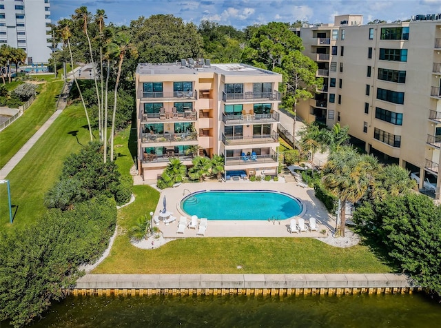 view of swimming pool featuring a yard and a patio area