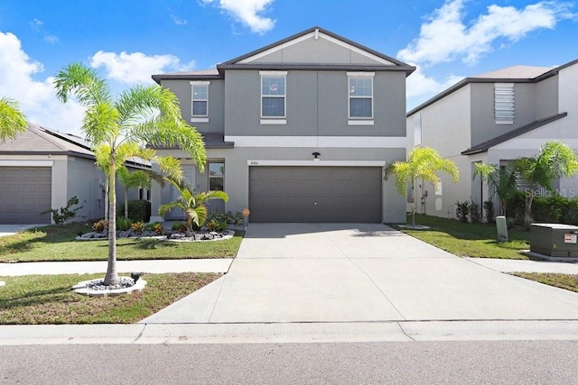 view of front of house featuring a front lawn and a garage