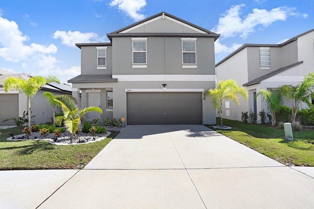 front of property with a front yard and a garage